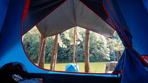 Tent against sky seen through glass window