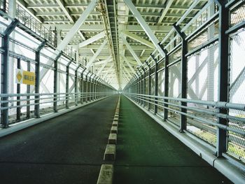 Empty road leading towards building