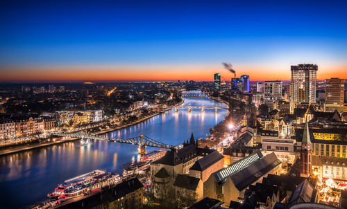 High angle view of city lit up at dusk