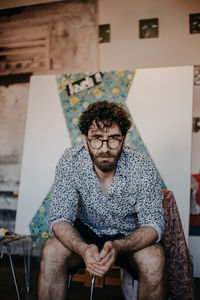 Portrait of young man sitting outdoors