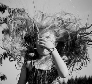 Young woman with arms outstretched in background