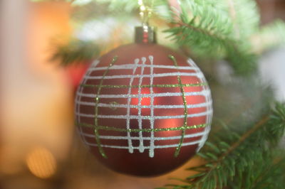 Close-up of bauble hanging on christmas tree