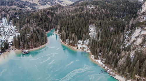 High angle view of river amidst trees during winter