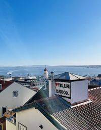 Lisbon rooftop against clear blue sky