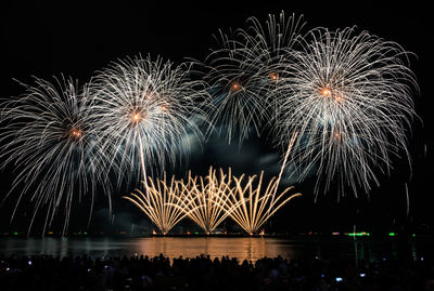 Low angle view of firework display at night