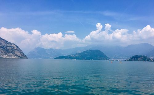 Scenic view of sea and mountains against sky