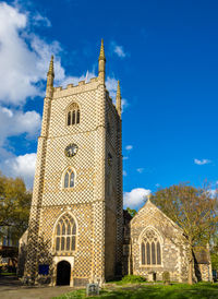 Low angle view of historic building against blue sky