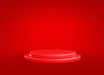 Close-up of illuminated lamp against red background