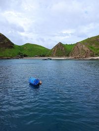 Scenic view of boat on mountain against sky