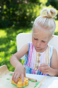 Close-up of cute girl holding ice cream on table