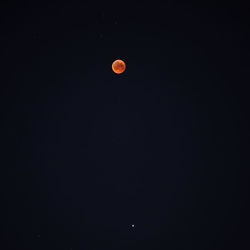 Low angle view of moon against sky at night