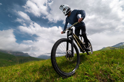 Man riding bicycle on field