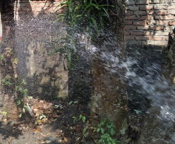 Scenic view of waterfall against wall