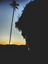 Side view of silhouette person against sky during sunset