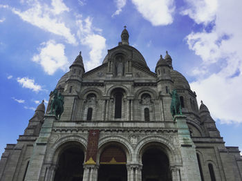 Low angle view of building against cloudy sky