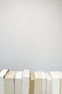 White background with books in a row at the bottom