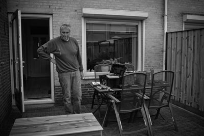 Portrait of carpenter standing in back yard