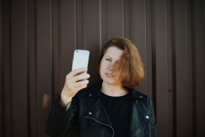 Portrait of young woman using mobile phone
