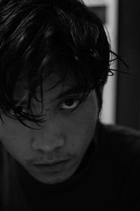 Close-up portrait of young man at home