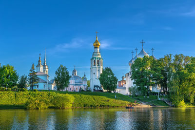 Church by river against sky