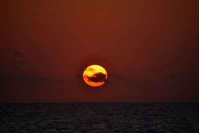 Scenic view of sea against romantic sky at sunset