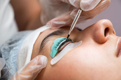 Close-up of woman doing eyelash treatment