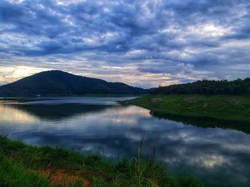 Scenic view of lake by mountains against sky