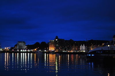 Illuminated church in front of river