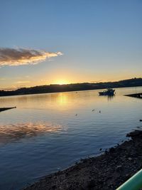 Scenic view of lake against sky during sunset