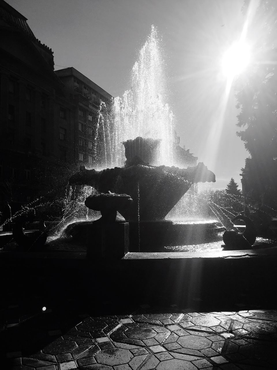 SILHOUETTE OF MAN SPLASHING FOUNTAIN