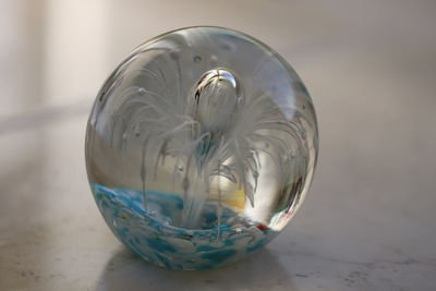 Close-up of glass ball on table