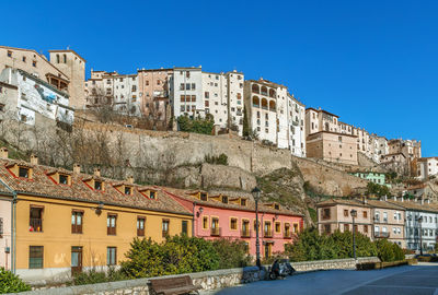 View of buildings in town against blue sky