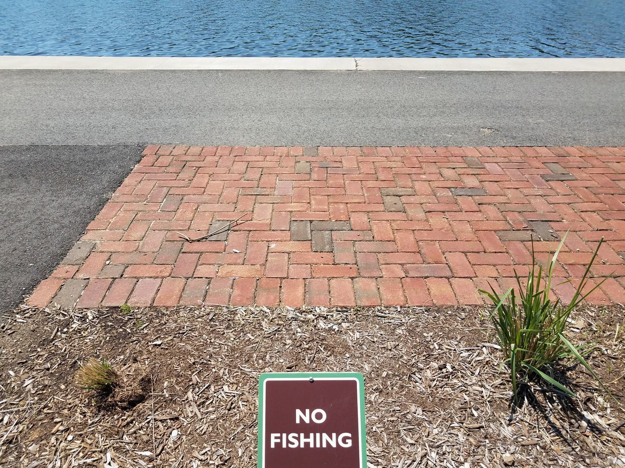 HIGH ANGLE VIEW OF TEXT WRITTEN ON COBBLESTONE STREET