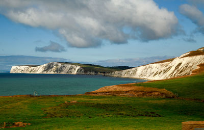 Scenic view of sea and mountains against sky