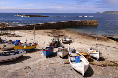 High angle view of boats moored on beach against sky