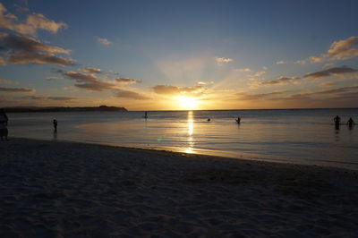 Scenic view of beach against sky during sunset