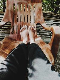 Low section of woman sitting on bench