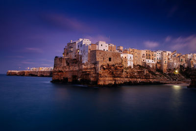 View of town by sea against sky