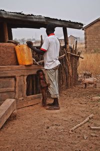 Rear view of man working at farm