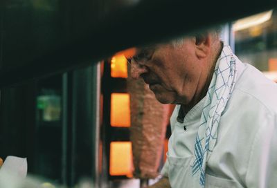 Portrait of man looking through window