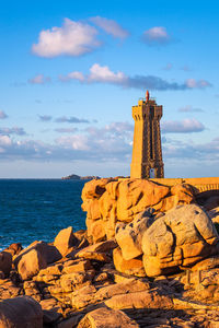 Rock formations by sea against sky