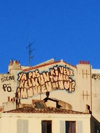 Low angle view of building against blue sky