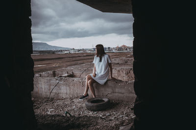 People on landscape against cloudy sky