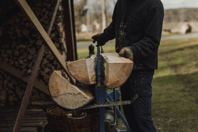 Man sawing log