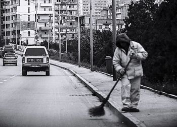 Rear view of man on motorcycle in city
