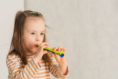 Child at home learning to play musical instruments. leisure and education at home. copy space