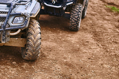 Close-up of motorcycle on dirt road