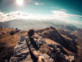 High angle view of man standing on mountain peak