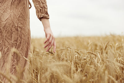 Midsection of woman standing on field