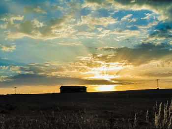 Scenic view of field against sky during sunset